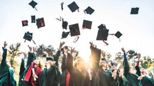 Graduates celebrating, tossing caps
